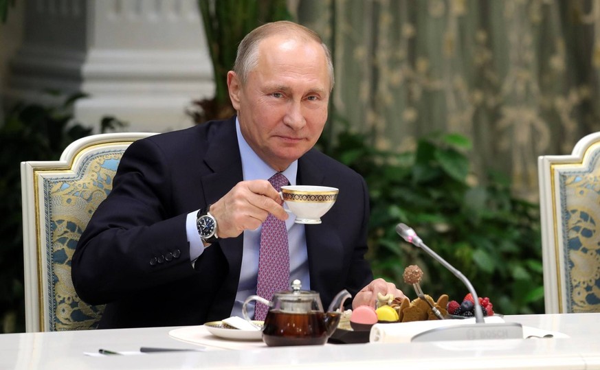 November 28, 2017 - Moscow, Russia - Russian President Vladimir Putin drinks a cup of tea during a meeting with the winners of the Family of the Year national contest November 28, 2017 in Moscow, Russ ...