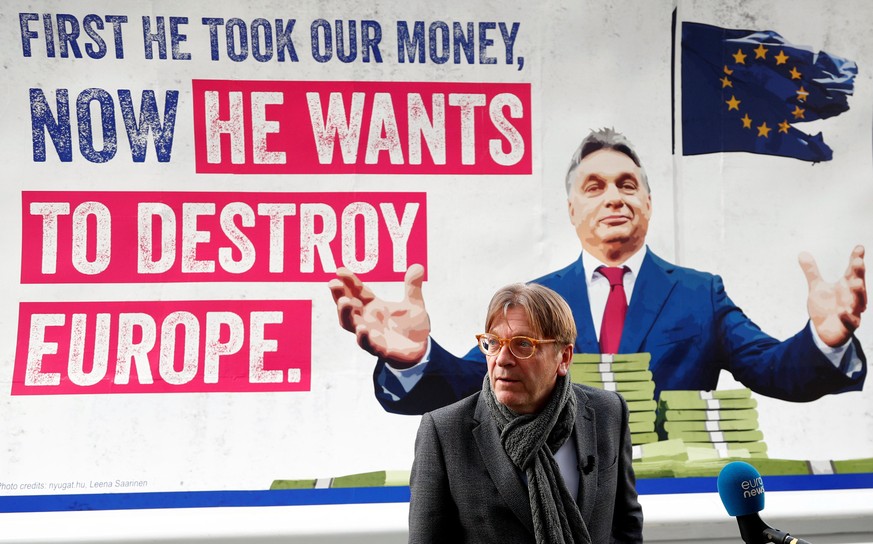 Guy Verhofstadt, President of the Group of the Alliance of Liberals and Democrats for Europe (ALDE), poses in front of a billboard truck showing a picture of Hungary&#039;s Prime Minister Viktor Orban ...