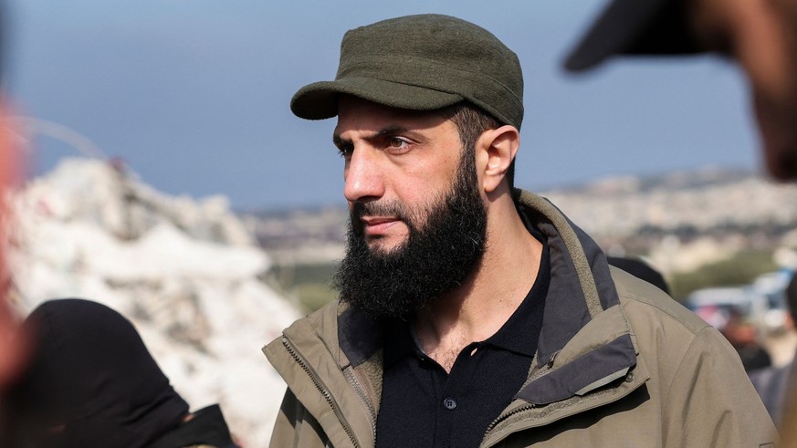 Hayat Tahrir al-Sham (HTS) jihadist group&#039;s chief Abu Mohamed al-Jolani checks the damage following an earthquake in the village of Besnaya in Syria&#039;s rebel-held northwestern Idlib province  ...