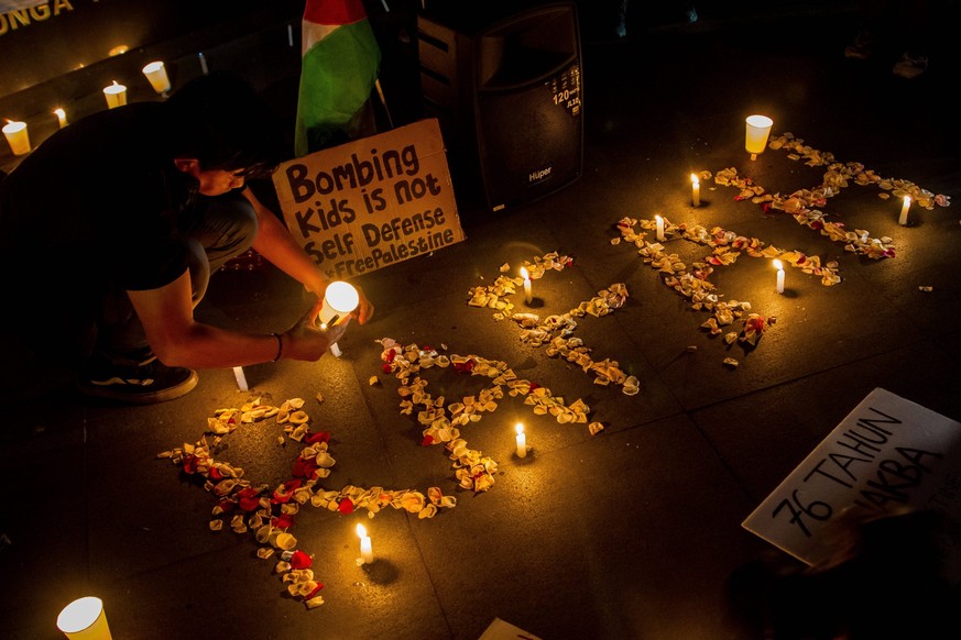 May 29, 2024, Bandung, West Java, Indonesia: People pray and light candles as a form of solidarity and support for the Palestinian people in Bandung. Art Solidarity for Palestine condemn the Israeli a ...