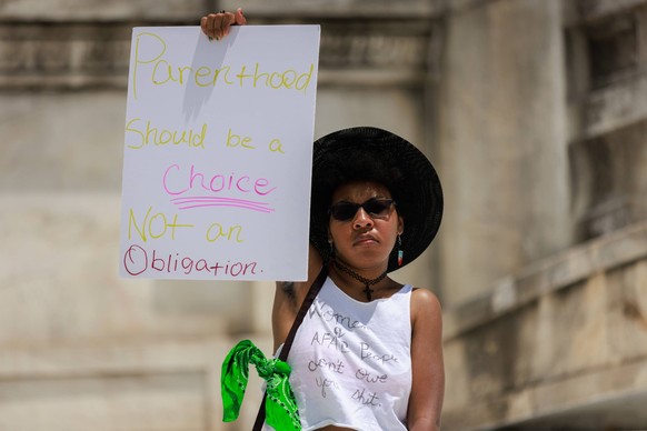 Womens March In DC A woman holds a sign at the Women s March at Columbus Circle in Washington, D.C. on June 24, 2023, the one year anniversary of the Supreme Court s overturning of Roe v. Wade. Washin ...