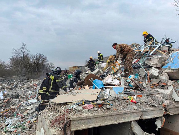 This photo released by Belgorod region governor Vyacheslav Gladkov&#039;s telegram channel on Monday, March 18, 2024, shows emergency ministry employees working at the destroyed building after shellin ...