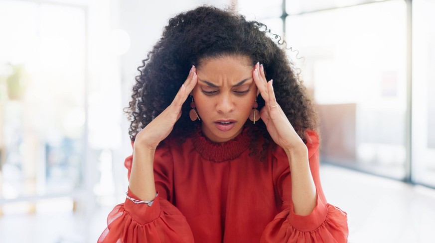 Laptop, typing and business woman with headache, pain or feeling sick in office workplace. Mental health, stress and exhausted female employee with burnout, depression or fatigue, anxiety or migraine. ...