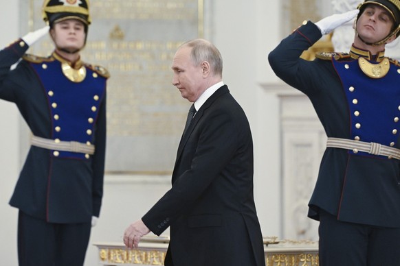 FILE - Russian President Vladimir Putin arrives at a ceremony to present medals on the eve of Heroes of the Fatherland Day at St. George Hall of the Grand Kremlin Palace, in Moscow, Russia, Friday, De ...