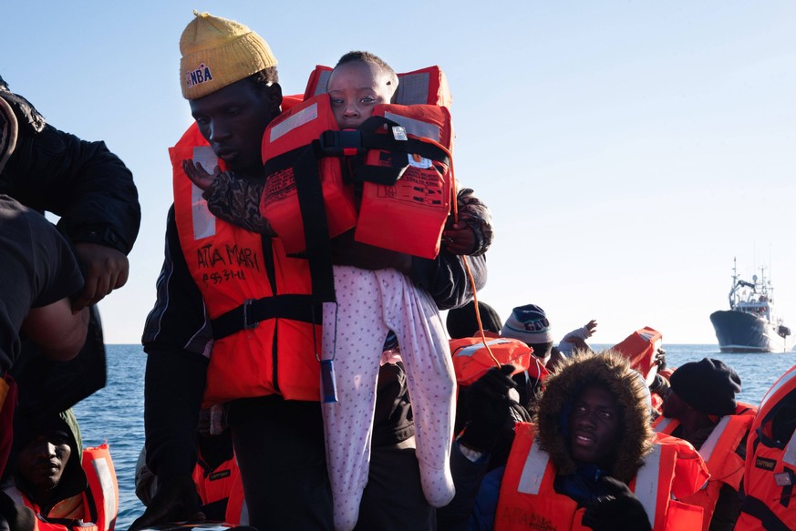February 21, 2023, SAR Italy, Italy: A man holds a seven-month-old baby girl in his arms to hand her over to the NGO Aita Mari sea rescue team on 21 February. At around 7:30 a.m. on Tuesday 21 Februar ...