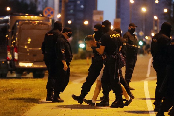 Belarus&#039; riot police detain a protester after the Belarusian presidential election in Minsk, Belarus, Sunday, Aug. 9, 2020. Police and protesters clashed in Belarus&#039; capital and the major ci ...