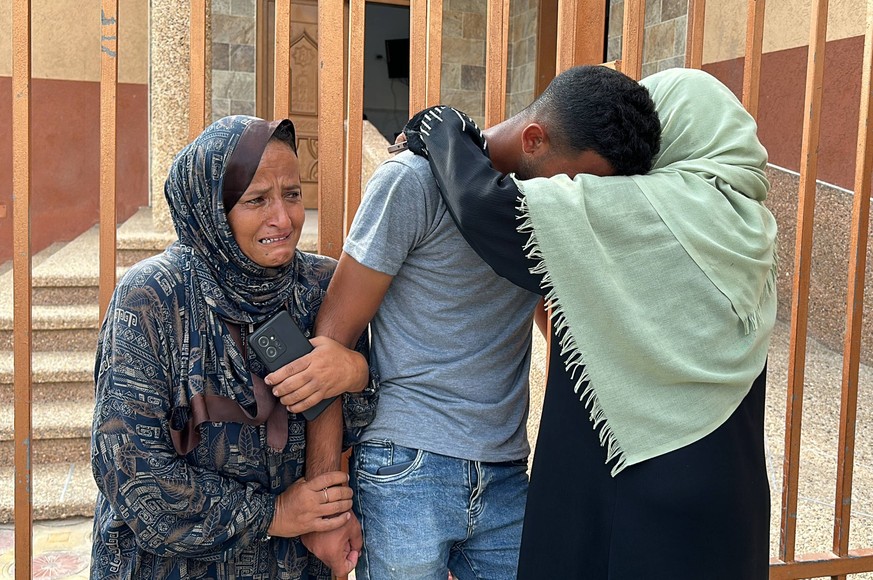 Relatives of the Palestinians died in Israeli attacks, mourn as they receive the dead bodies from the morgue of Al-Aqsa Hospital Relatives of the Palestinians died in Israeli attacks, mourn as they re ...