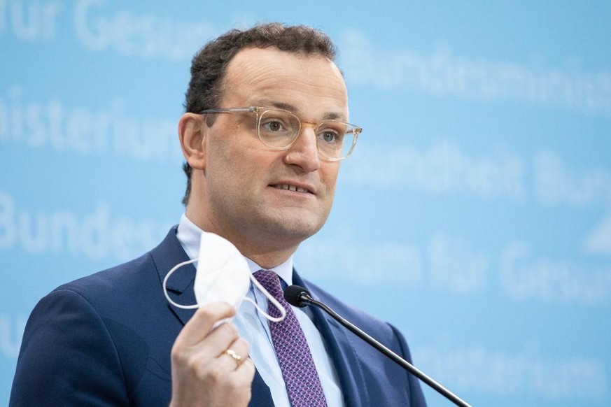 BERLIN, GERMANY - JANUARY 18: Health Minister Jens Spahn holds a protective FPP2 mask as he speaks during a press conference on January 18, 2021 in Berlin, Germany. The laboratories will be obliged to ...