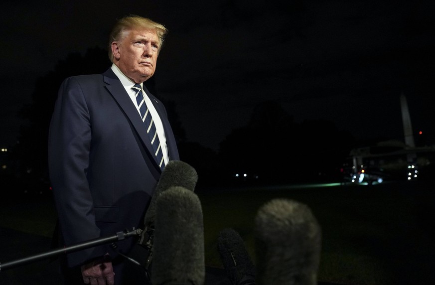 United States President Donald J. Trump speaks with members of the media as he departs the White House in Washington, DC en route to Joint Base Andrews on Friday, August 23, 2019. Trump is traveling t ...