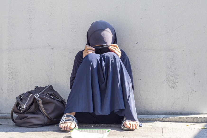 ISTANBUL - OCT 22: Muslim girl, woman sitting in a street of the city. Muslim woman with closed face begging for alms in Istanbul, October 22. 2021 in Turkey. xkwx muslim, woman, taliban, girl, dress, ...