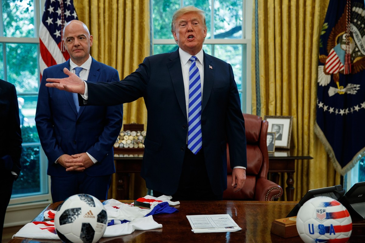 FILE - FIFA president Gianni Infantino, left, watches as President Donald Trump speaks to reporters during a meeting in the Oval Office of the White House, Aug. 28, 2018, in Washington. (AP Photo/Evan ...