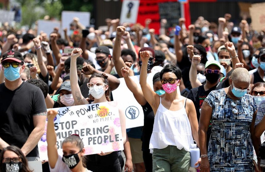 WEST ORANGE, NEW JERSEY - JUNE 06: Community members observe a moment of silence that lasted 8 minutes and 46 seconds to honor George Floyd during a Black Lives Matter protest at the Municipal Buildin ...