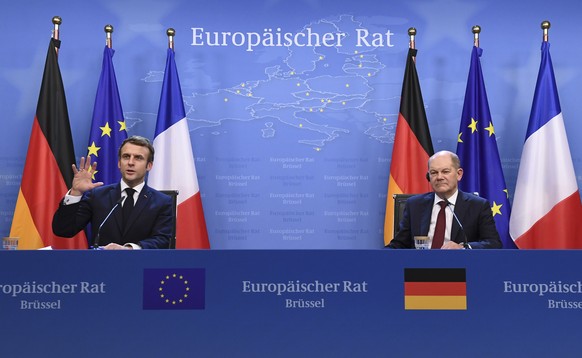 German Chancellor Olaf Scholz, right, and French President Emmanuel Macron address a media conference at the conclusion of an EU Summit in Brussels, Friday, Dec. 17, 2021. European Union leaders met f ...