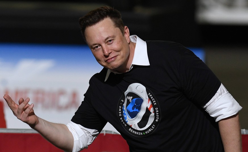 May 30, 2020, Cape Canaveral, United States: SpaceX founder Elon Musk gestures to the audience after being recognized by U.S. President Donald Trump at NASA s Vehicle Assembly Building following the s ...