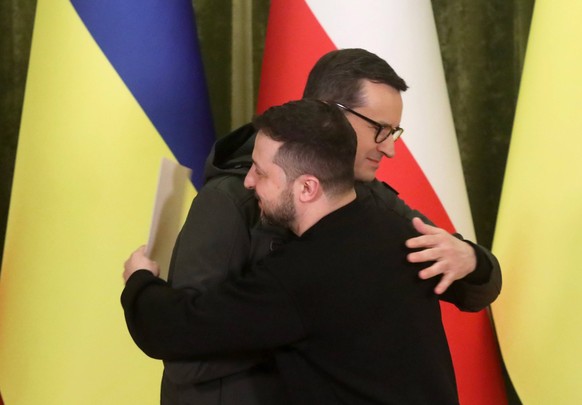 KYIV, UKRAINE - FEBRUARY 24, 2023 - President of Ukraine Volodymyr Zelenskyy R and Prime Minister of the Republic of Poland Mateusz Morawiecki share a hug during a joint briefing, Kyiv, capital of Ukr ...