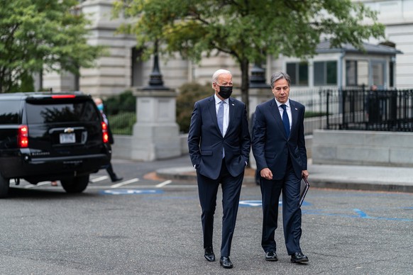 October 12, 2021 - Washington, D.C., USA - President Joe Biden walks with Secretary of State Antony Blinken across West Executive Avenue at the White House, Tuesday, October 12, 2021, after a virtual  ...