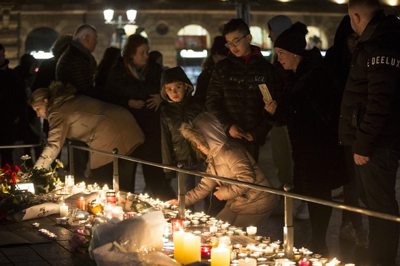 December 12, 2018 - Strasbourg, France - Mourners are seen lighting candles at the Christmas market in Strasbourg. Mourners gathered near the Strasbourg Christmas market where candles were lit in reme ...