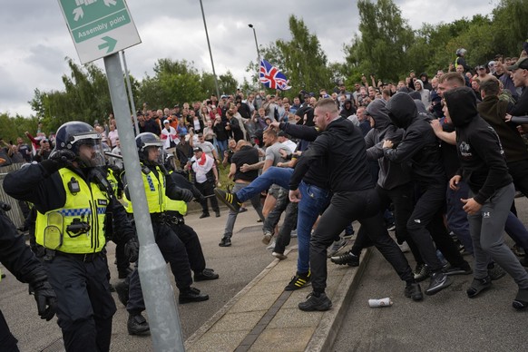 Trouble flares during an anti-immigration protest outside the Holiday Inn Express in Rotherham, England, Sunday Aug. 4, 2024. (Danny Lawson/PA via AP)