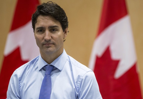 Canadian Prime Minister Justin Trudeau listens during an opening prayer before a discussion with the Indigenous Advisory and Monitoring Committee on the Cheam First Nation near Chilliwack, British Col ...