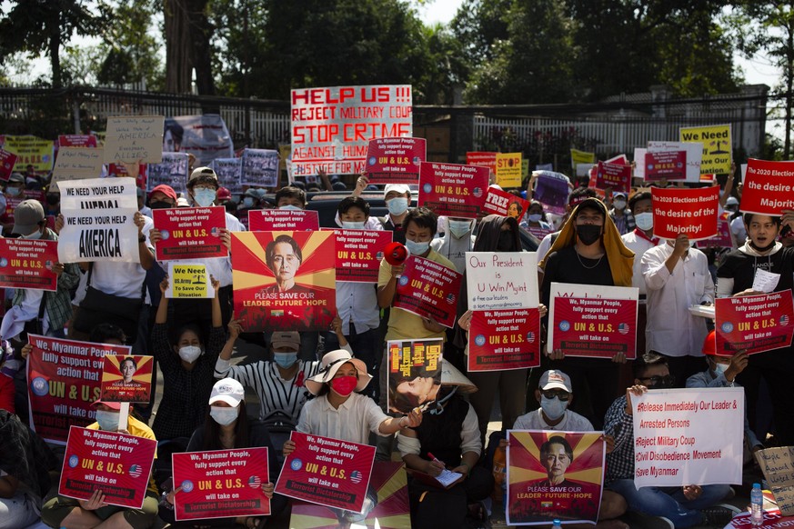 February 14, 2021, Yangon, Myanmar: Protesters hold placards during the demonstration..Thousands of people took to the streets of Yangon on the ninth day of protest against the military coup and deman ...