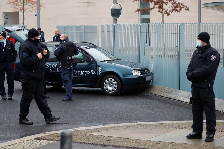 Police secures the area after a man crashed with his car into the gate of the main entrance of the chancellery in Berlin, the office of German Chancellor Angela Merkel in Berlin, Germany, November 25, ...