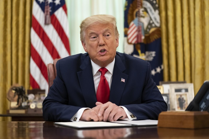 President Donald Trump speaks before signing a full pardon for Alice Johnson in the Oval Office of the White House, Friday, Aug. 28, 2020, in Washington. (AP Photo/Evan Vucci)