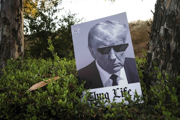 A sign is left behind by Trump supporters as they rally during the second Republican presidential debate outside the Ronald Reagan Presidential Library in Simi Valley, Calif., on Wednesday, Sept. 27,  ...