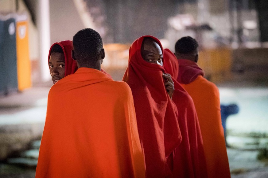 June 27, 2019 - Malaga, Spain - A group of migrants queues before being attended by the Red Cross at Malaga s port, in Malaga, Spain, on June 28, 2019. Even though the number of migrants reaching Euro ...