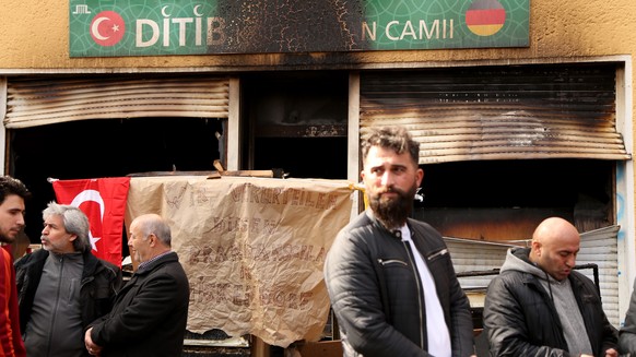 BERLIN, GERMANY - MARCH 11: Congregation members stands outside the Koca Sinan Camii mosque the day after a fire in the building the previous night, on March 11, 2018 in Berlin, Germany. Witnesses cla ...