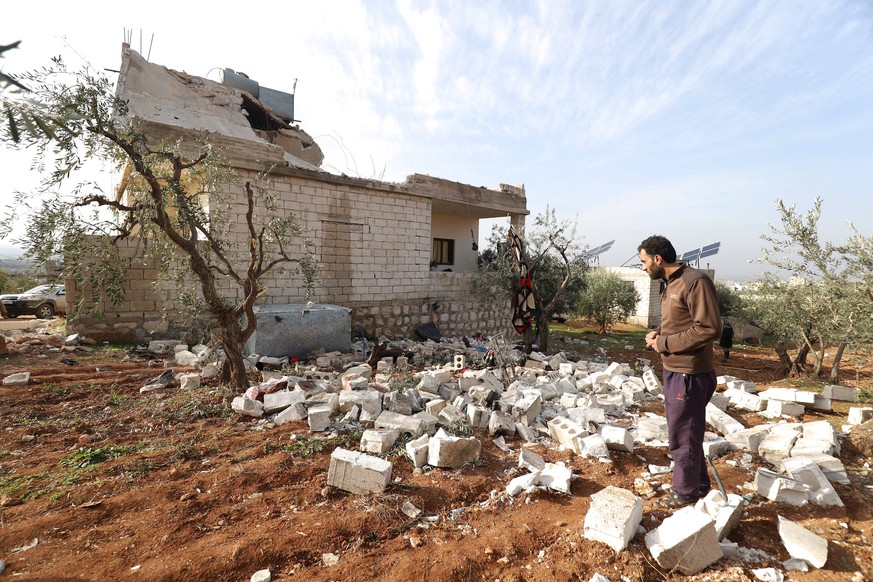 People check a destroyed house after an operation by the U.S. military in the Syrian village of Atmeh, in Idlib province, Syria, Thursday, February. 3, 2022. U.S. special forces carried out what the P ...