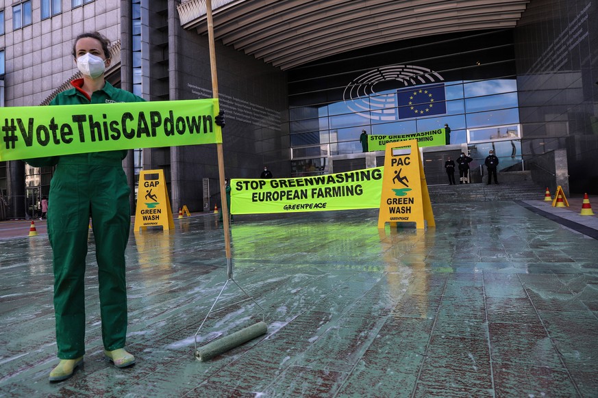 May 26, 2021, Brussels, Puglia, Belgium: Greenpeace activists protest in front of the European Parliament while the talks on the Common Agricultural Policy CAP take place in the European Parliament. B ...