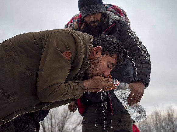 December 14, 2019, Vucjak, Bosnia and Herzegovina: Afghan refugees washing at abandoned Vucjak illegal camp which was emptied by authorities in December 2019..In Bosnia and Herzegovina around 8,000 re ...