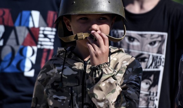 Russia Field Childrens Camp 8476433 11.07.2023 A boy is seen at a summer military camp in Nikolaevka, Crimea, Russia. Children from Crimea and Kherson region will live in tents, practice military-styl ...