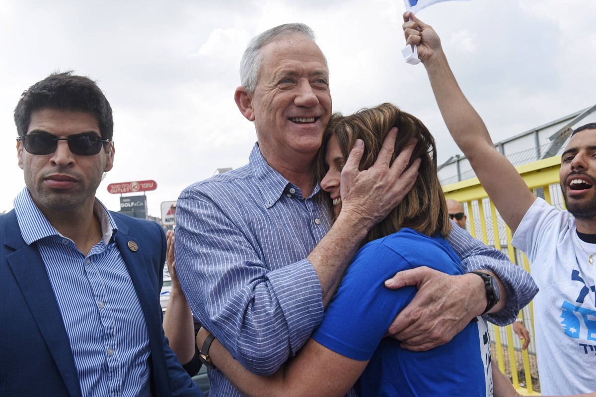 Benny Gantz, leader of the new Israeli Blue and White centrist party, hugs his wife, Revital, at a campaign stop at the mall in Kiryat Ekron, Israel, April 5, 2019. Gantz, a former chief of staff and  ...