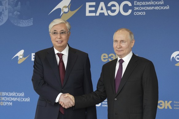 In this photo released by Roscongress Foundation, Russian President Vladimir Putin, right, and Kazakh President Kassym-Jomart Tokayev pose for a photo prior to the plenary session of the Eurasian Econ ...