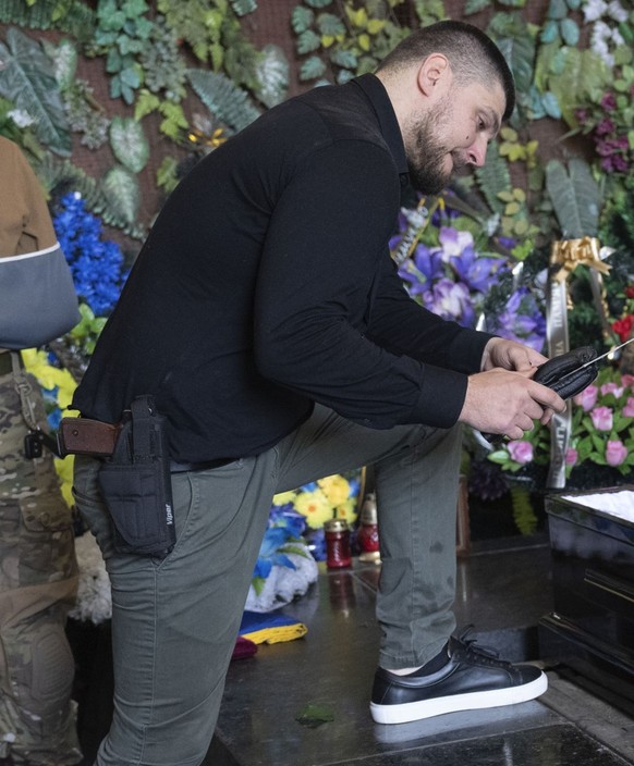 Denis Kapustin, leader of the Russian Volunteer Corps, pays the last respect to his fellow soldier Daniil Maznik during a farewell ceremony in Kyiv, Ukraine, Saturday, June 10, 2023. Maznik was killed ...