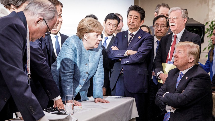 German Chancellor Angela Merkel speaks to U.S. President Donald Trump during the second day of the G7 meeting in Charlevoix city of La Malbaie, Quebec, Canada, June 9, 2018. Bundesregierung/Jesco Denz ...