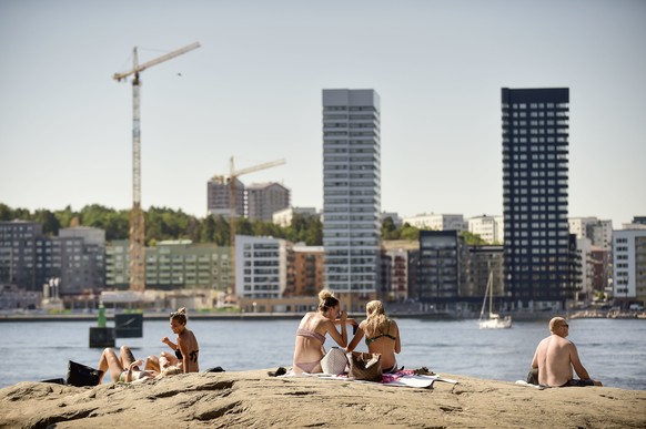 People sunbathe during a hot summer day in the center of Stockholm, Sweden, Monday, June 16, 2018.(Hossein Salmanzadeh/TT via AP)