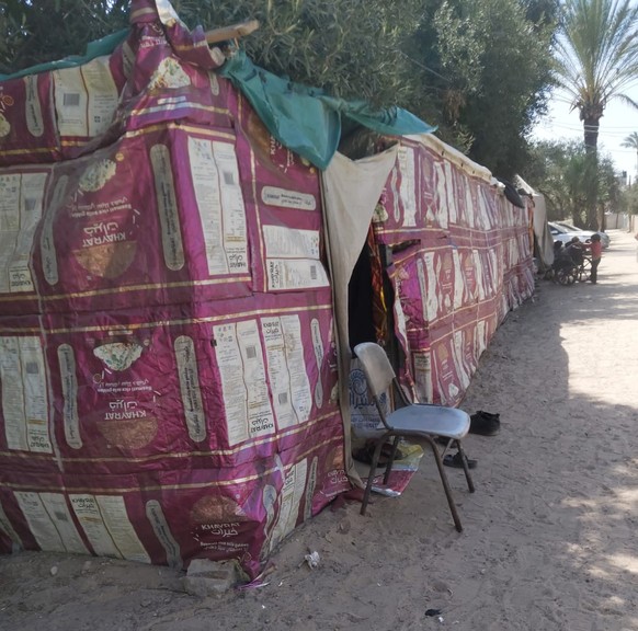 A tent in Gaza made out of empty fabric rice sacks that the family sew together and turned into their home. This is one of many innovations that Gaza families have come up with to cope with lack of sh ...