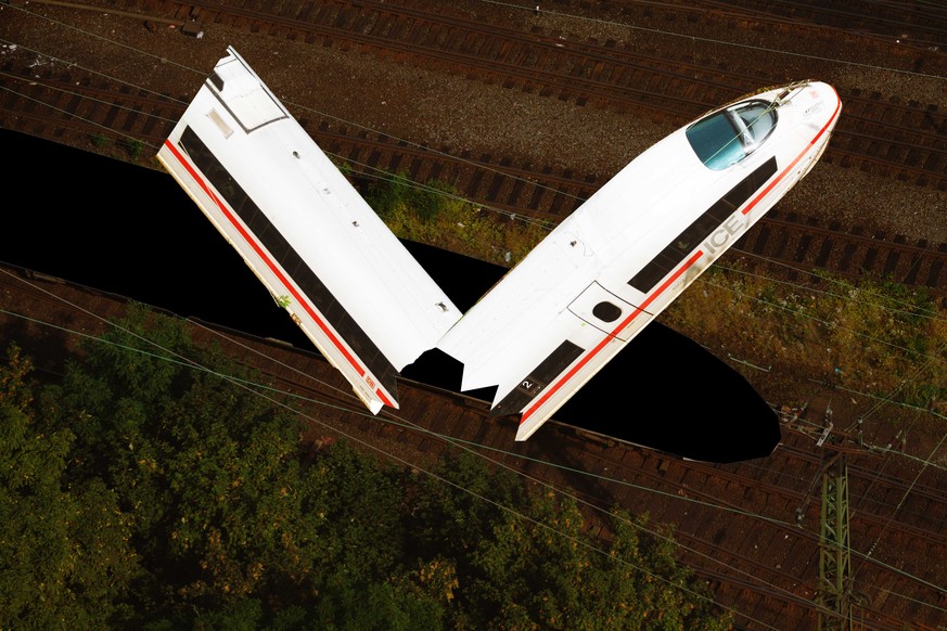 Cologne, Germany - August, 22nd 2013: Aerial view of driving intercity ICE of German Deutsche Bahn. Train is passing Cologne between river Rhine and fairtrade Messe Deutz.