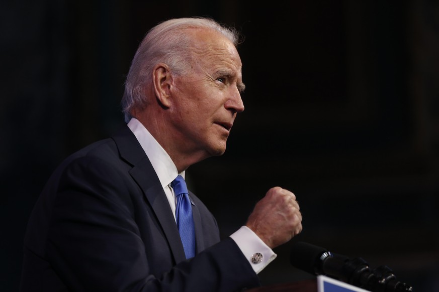 WILMINGTON, DE - DECEMBER 14: President-elect Joe Biden clinches his fist as he speaks about receiving the 270 electoral college votes needed to become the 46th President of the United States at the Q ...