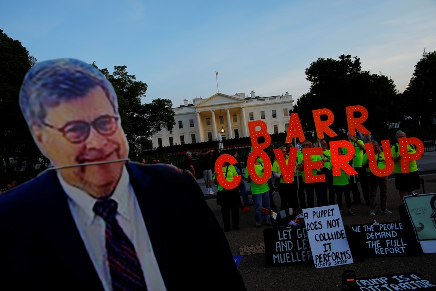 A cardboard cutout of U.S. Attorney General William Barr is seen as protesters hold signs which read &quot;Barr Coverup,&quot; following the release of the Mueller report on U.S. President Donald Trum ...