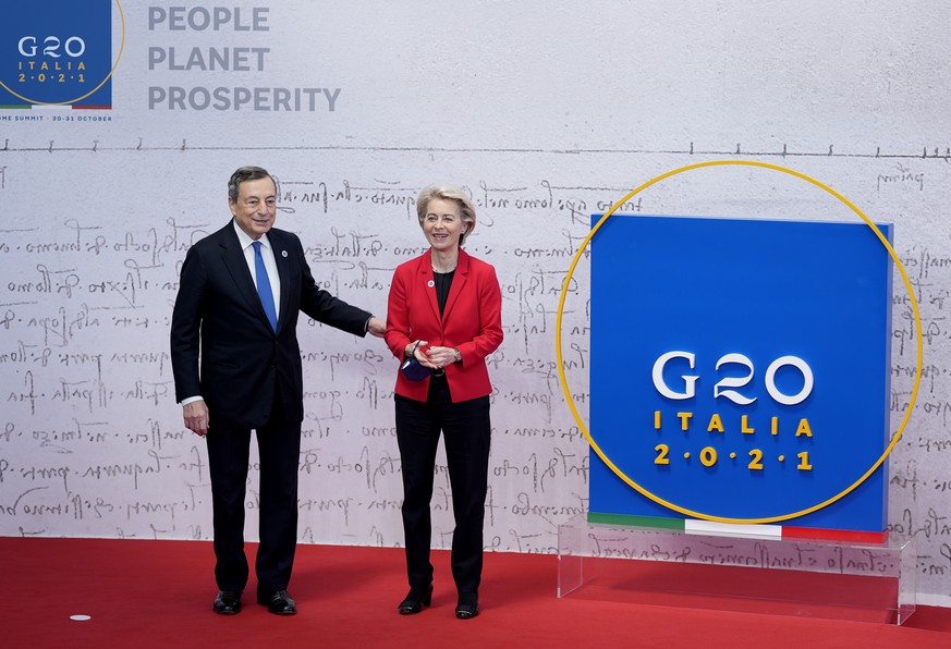 European Commission President Ursula von der Leyen, right, poses with Italy's Prime Minister Mario Draghi during arrivals at the La Nuvola conference center for the G20 summit in Rome, Saturday, Oct.  ...