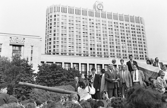 MOSCOW, RUSSIA. First Russian President Boris Yeltsin (front L) makes a speech as he stands atop an armoured vehicle next to his bodyguard Alexander Korzhakov (front 2nd L) outside the building of the ...
