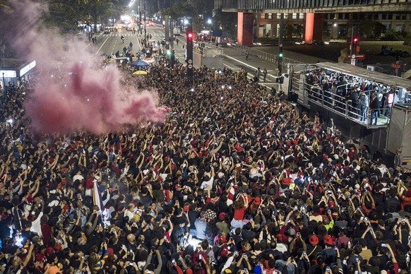 Former Brazilian President Luiz Inacio Lula da Silva, right, who is running for president again, speaks to supporters after general election polls closed in in Sao Paulo, Brazil, Sunday, Oct. 2, 2022. ...