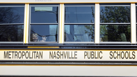 27.03.2023, USA, Nashville: Ein Kind weint im Bus, als es die Covenant School verlässt, nachdem hier Schüsse gefallen waren. Bei Schüssen an einer Grundschule in Nashville im US-Bundesstaat Tennessee  ...