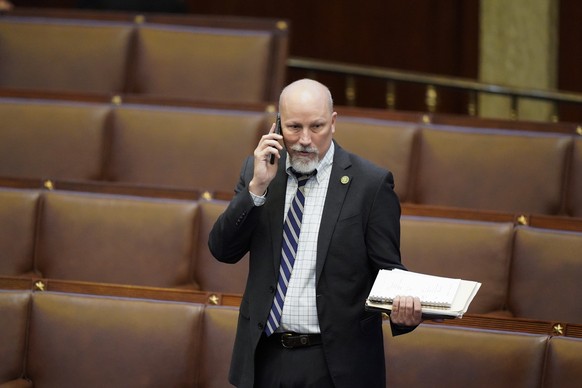 Rep. Chip Roy, R-Texas, talks on the phone in the House chamber at the conclusion of an evening session after six failed votes to elect a speaker and convene the 118th Congress in Washington, Wednesda ...