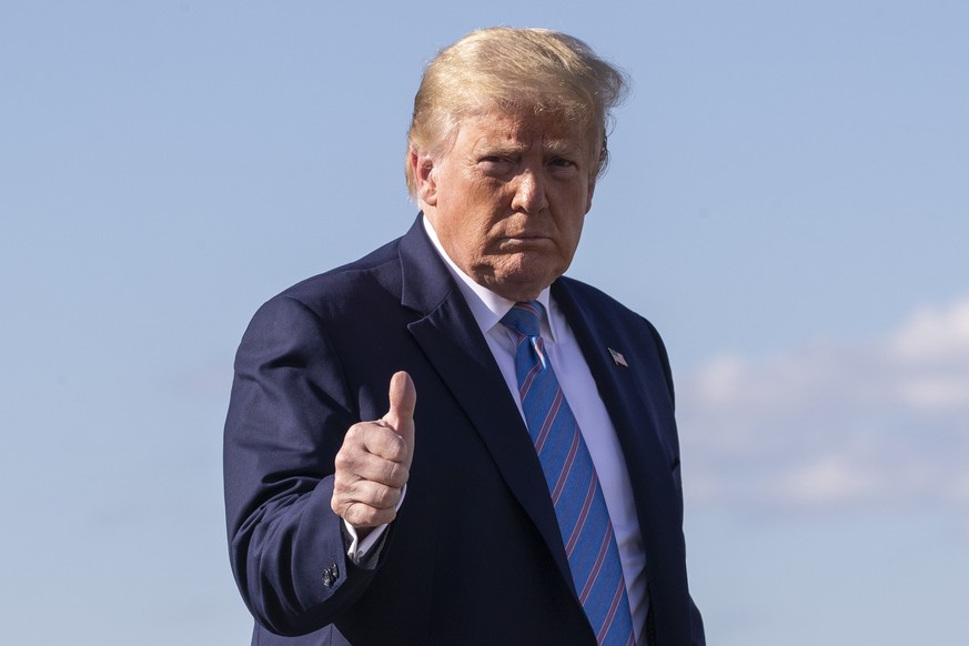 President Donald Trump gives a thumbs-up while walking across the tarmac as he boards Air Force One at Morristown Municipal Airport, Sunday, June 14, 2020, in Morristown, N.J. Trump is returning to Wa ...