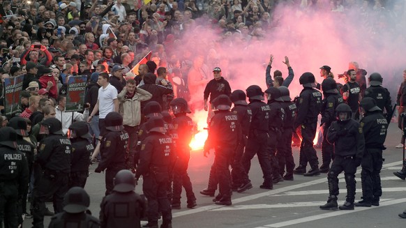 Protesters light fireworks during a far-right demonstration in Chemnitz, Germany, Monday, Aug. 27, 2018 after a man has died and two others were injured in an altercation between several people of &qu ...