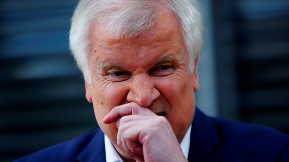 German Interior Minister Horst Seehofer talks to journalists after the ARD- Sommerinterview in front of the Reichstag building in Berlin, Germany August 5, 2018. REUTERS/Joachim Herrmann